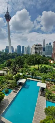 a swimming pool with a view of a city at Holiday Heaven in Kuala Lumpur