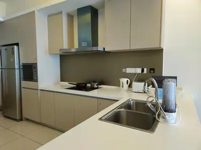 a kitchen with a sink and a refrigerator at Holiday Heaven in Kuala Lumpur