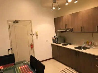 a small kitchen with a table and a sink at Parkview KLCC in Kuala Lumpur