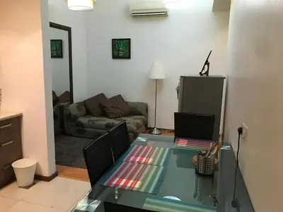 a living room with a glass table and a couch at Parkview KLCC in Kuala Lumpur