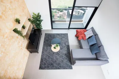 an overhead view of a living room with a couch and a tv at The Establishment KL Sentral Bangsar by Plush in Kuala Lumpur