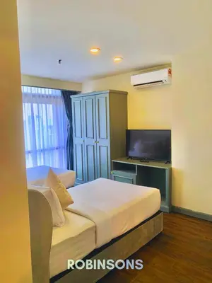 a hotel room with a bed and a television at Robinsons at Times Square Kuala Lumpur in Kuala Lumpur