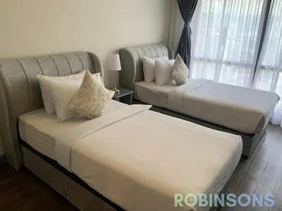 a hotel room with two beds and a couch at Robinsons at Times Square Kuala Lumpur in Kuala Lumpur