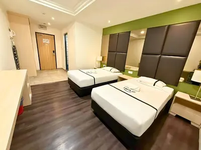 a hotel room with two beds and a bathroom at Seeds Hotel Ampang Point in Kuala Lumpur
