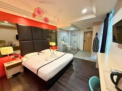 a bedroom with a large bed and a bathroom at Seeds Hotel Ampang Point in Kuala Lumpur
