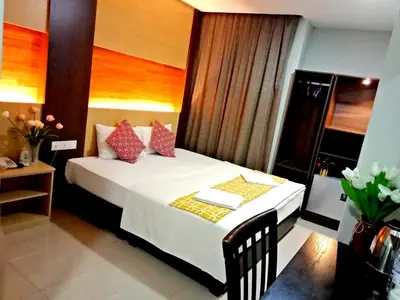a bedroom with a white bed with red pillows at Eazy Hotel at Ampang in Batu Empat