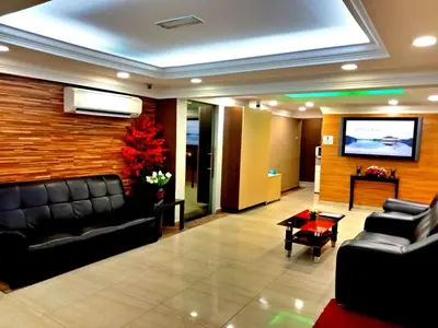 a lobby with a couch and a flat screen tv at Eazy Hotel at Ampang in Batu Empat
