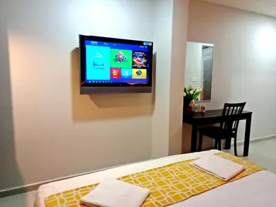 a bedroom with a bed and a flat screen tv on the wall at Eazy Hotel at Ampang in Batu Empat