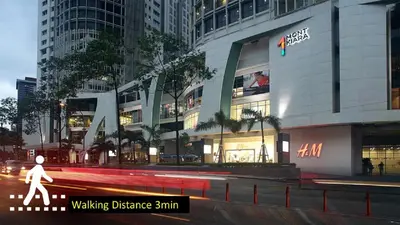 a building with a person walking in front of it at The Signature Serviced Suites Kuala Lumpur in Kuala Lumpur