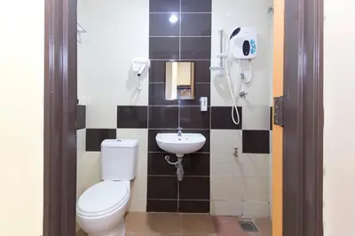 a bathroom with a toilet and a sink at Hotel Raja Bot in Kuala Lumpur
