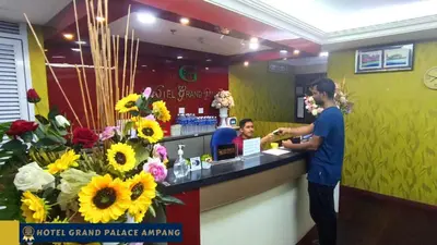 a man standing at a counter in a flower shop at Hotel Grand Palace Ampang in Ampang