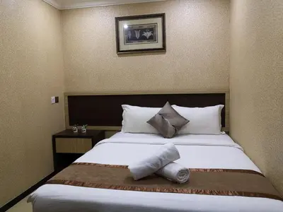 a hotel room with a large bed with two pillows at Hotel Grand Palace Ampang in Ampang