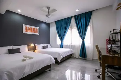 a hotel room with two beds and a window at The Forum Condominium by LaFabrica in Kuala Lumpur