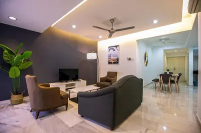 a living room with a couch and chairs and a tv at The Forum Condominium by LaFabrica in Kuala Lumpur
