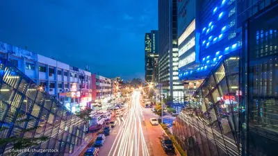 a busy city street at night with buildings and cars at CITI HOTEL @ KL SENTRAL in Kuala Lumpur