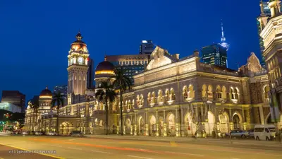 a large building with a clock tower in a city at CITI HOTEL @ KL SENTRAL in Kuala Lumpur