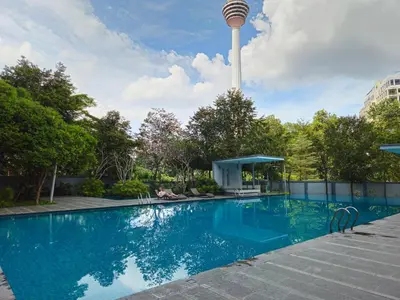 a swimming pool with a tower in the background at Holiday Paradise in Kuala Lumpur