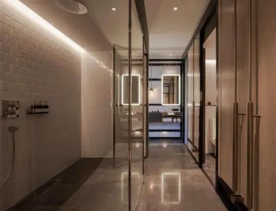 a bathroom with a glass shower stall and a sink at Alila Bangsar Kuala Lumpur in Kuala Lumpur