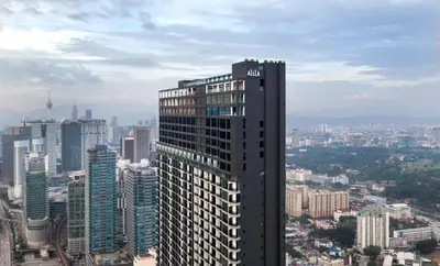 a tall building in the middle of a city at Alila Bangsar Kuala Lumpur in Kuala Lumpur