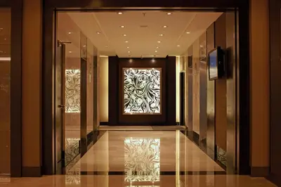 a hallway with a door with a painting on it at Furama Bukit Bintang, Kuala Lumpur in Kuala Lumpur