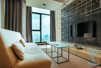 a hotel room with a tv and a couch and a table at Expressionz Professional Suites by MyKey in Kuala Lumpur