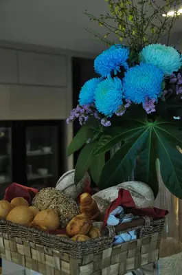 a basket with a vase of blue flowers on top at Damas Suites & Residences Kuala Lumpur in Kuala Lumpur