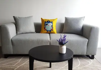 a couch with pillows and a table in a living room at KL Sentral, EST Bangsar by SkyLimit Suites in Kuala Lumpur