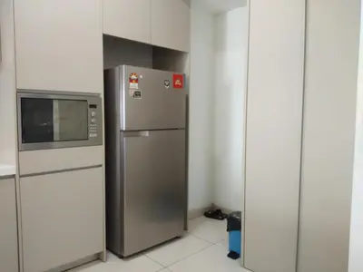 a kitchen with a refrigerator and a microwave at 3 Bedroom Cozy apartmet in Kuala Lumpur