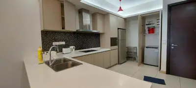 a kitchen with a sink and a refrigerator at 3 Bedroom Cozy apartmet in Kuala Lumpur