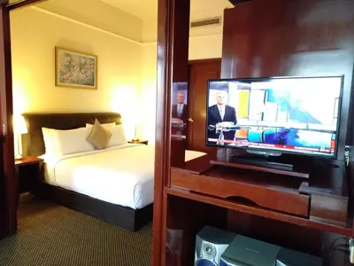 a hotel room with a bed and a flat screen tv at Grand Service Apartment @ Times Square in Kuala Lumpur