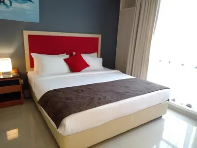 a bedroom with a large bed with a red headboard at Grand Service Apartment @ Times Square in Kuala Lumpur