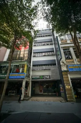 a man standing in front of a building at Hotel A-One in Kuala Lumpur
