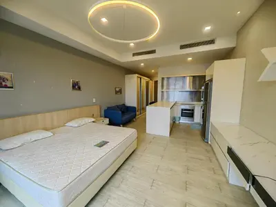 a bedroom with a large bed and a blue couch at M CITY Kl City in Kuala Lumpur