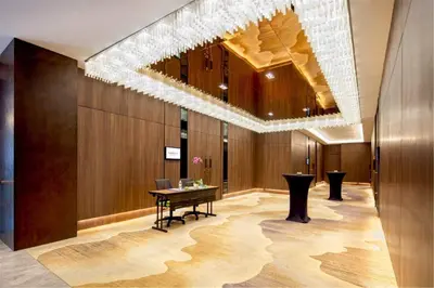 a lobby with a table and a chandelier at Dorsett Hartamas Kuala Lumpur in Kuala Lumpur
