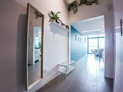a hallway with a mirror and a dining room at EST Suites Bangsar by Airhost in Kuala Lumpur