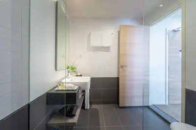 a bathroom with a sink and a toilet and a mirror at Hilton Garden Inn Kuala Lumpur - South in Kuala Lumpur