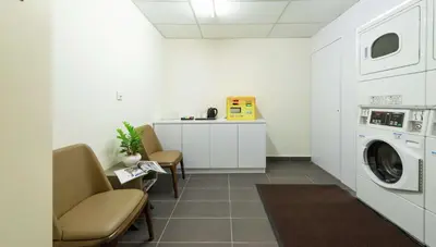 a laundry room with a washer and dryer at Hilton Garden Inn Kuala Lumpur - South in Kuala Lumpur