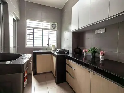 a kitchen with a black counter top and a sink at Setapak TerataiMewahApart to15min KLCC 217 in Kuala Lumpur