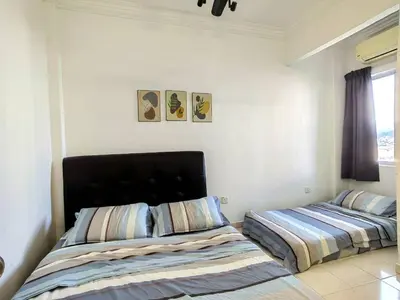 a bedroom with two beds and a window at Setapak TerataiMewahApart to15min KLCC 217 in Kuala Lumpur