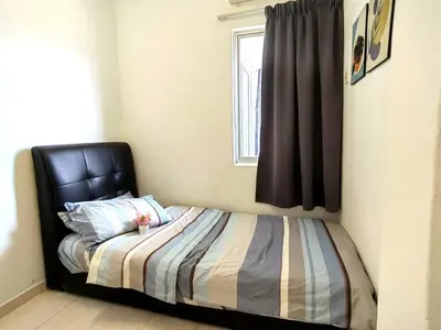 a bed with a black headboard in a bedroom at Setapak TerataiMewahApart to15min KLCC 217 in Kuala Lumpur