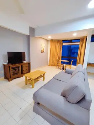 a living room with a couch and a flat screen tv at Fahrenheit 88 Pavillion Bukit Bintang Street AJ-HOME in Kuala Lumpur