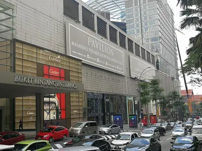 a busy city street with cars parked in front of a building at Fahrenheit 88 Pavillion Bukit Bintang Street AJ-HOME in Kuala Lumpur