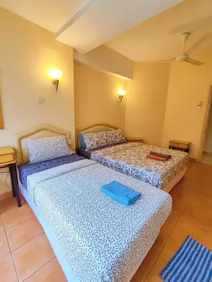 two beds in a room with blue sheets at Fahrenheit 88 Pavillion Bukit Bintang Street AJ-HOME in Kuala Lumpur