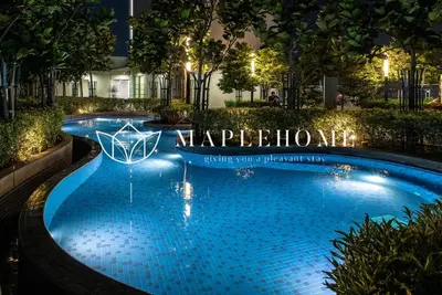 a swimming pool at night with a sign that reads happyflow at The Robertson Kuala Lumpur in Kuala Lumpur