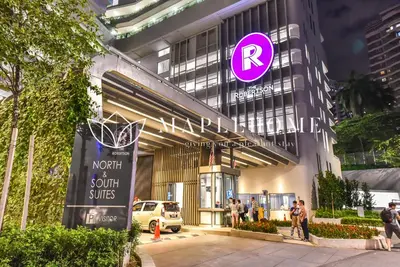 a building with a purple sign on the side of it at The Robertson Kuala Lumpur in Kuala Lumpur