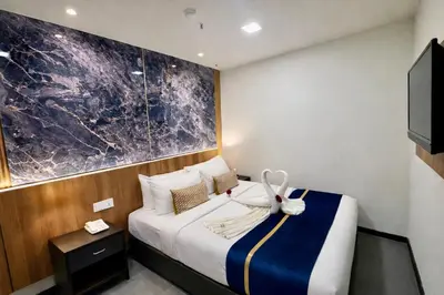 a hotel room with a bed and a tv at Swiss Hotel Kuala Lumpur in Kuala Lumpur