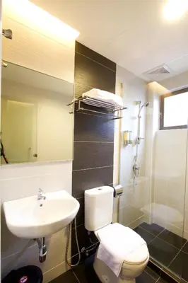 a bathroom with a white toilet and a sink at Lotus Hotel Masjid India in Kuala Lumpur