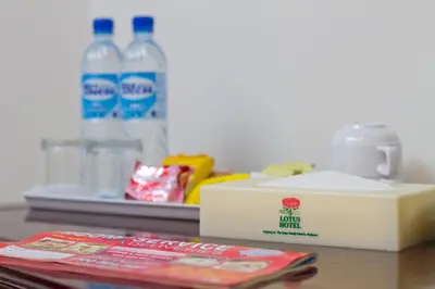 a table with a box of milk and a bottle of water at Lotus Hotel Masjid India in Kuala Lumpur