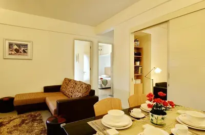 a living room with a couch and a table at One-Stop Residence & Hotel in Kuala Lumpur