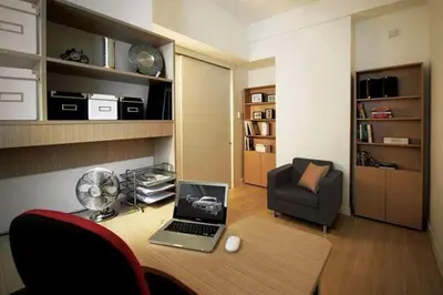 a room with a desk with a laptop and a chair at One-Stop Residence & Hotel in Kuala Lumpur